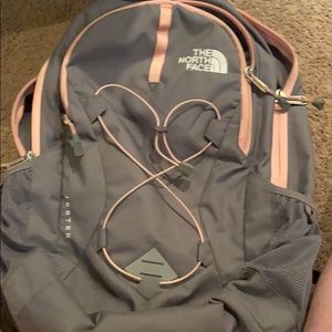 Grey and pink north face back pack